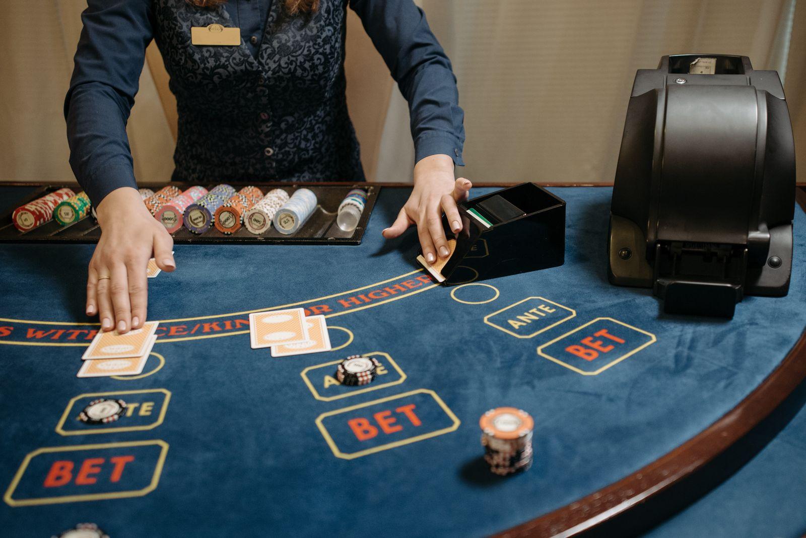 Live dealer dealing cards at a baccarat table, the most played of the live casino games Malaysia players meet